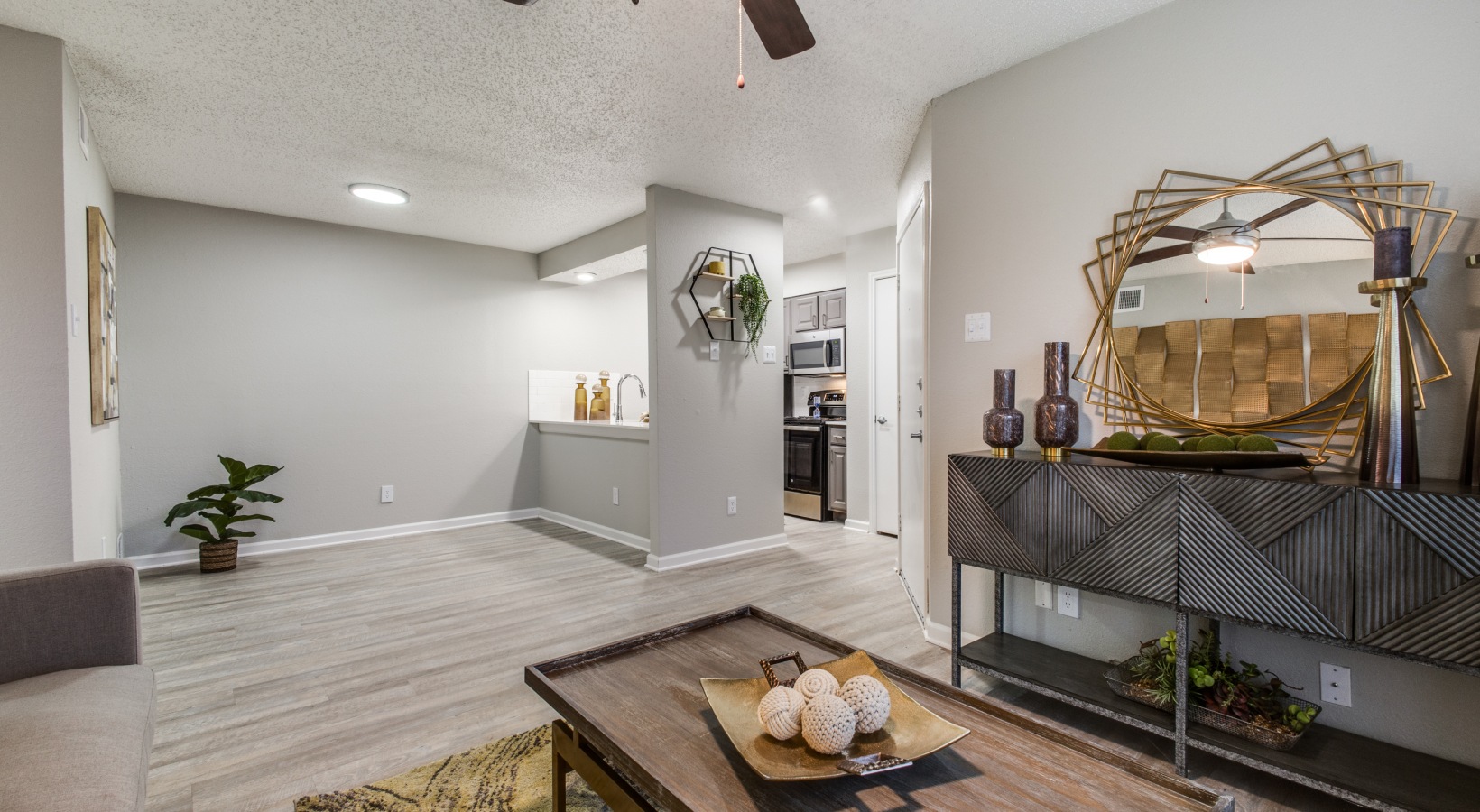 the living room has a ceiling fan and a coffee table at The Wilder