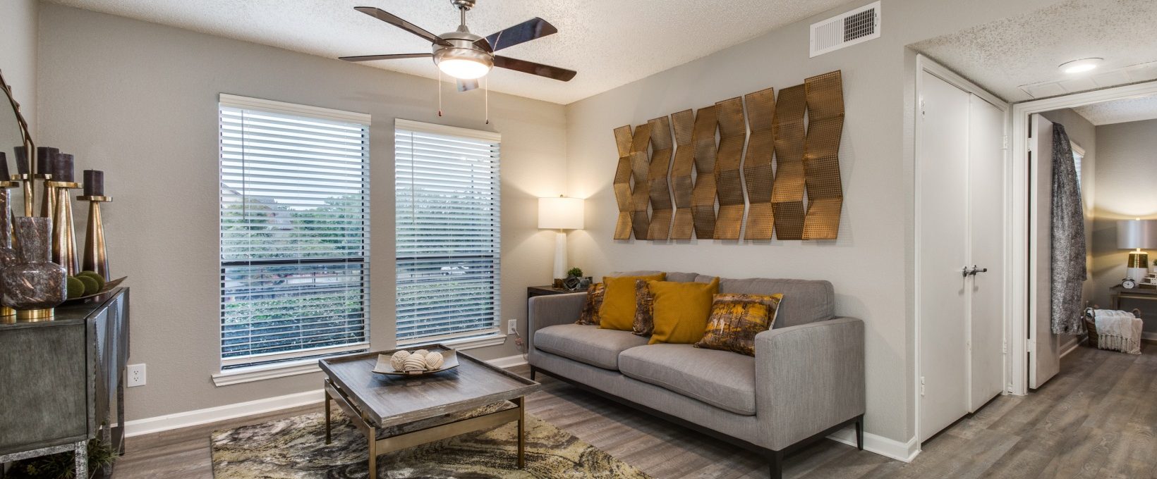 the living room has a ceiling fan and a couch at The Wilder