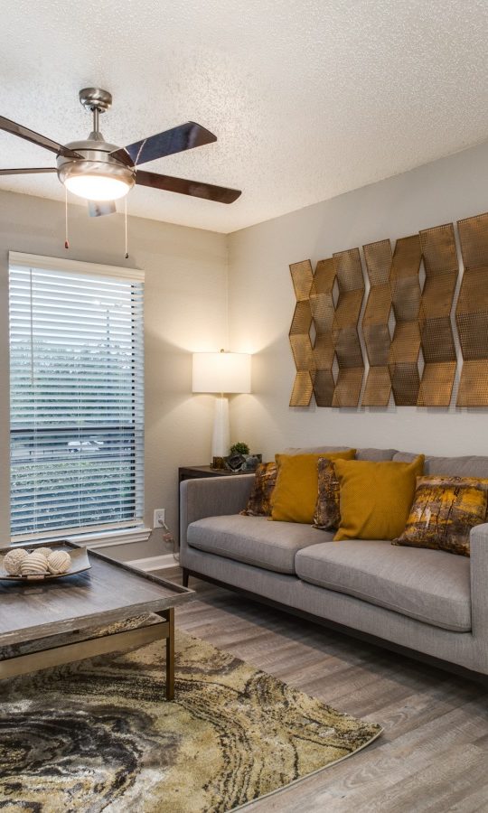 the living room has a ceiling fan and a couch at The Wilder