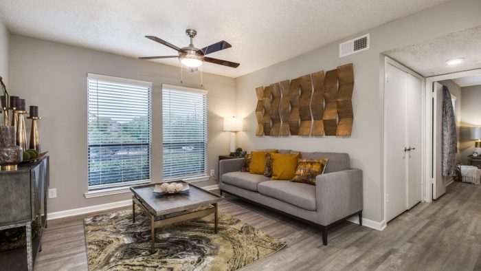 the living room has a ceiling fan and a couch at The Wilder