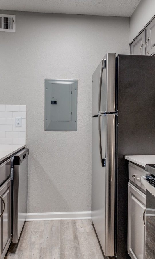 kitchen with stainless steel appliances and white cabinets at The Wilder