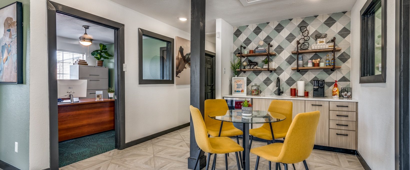 a kitchen with yellow chairs and a table at The Wilder