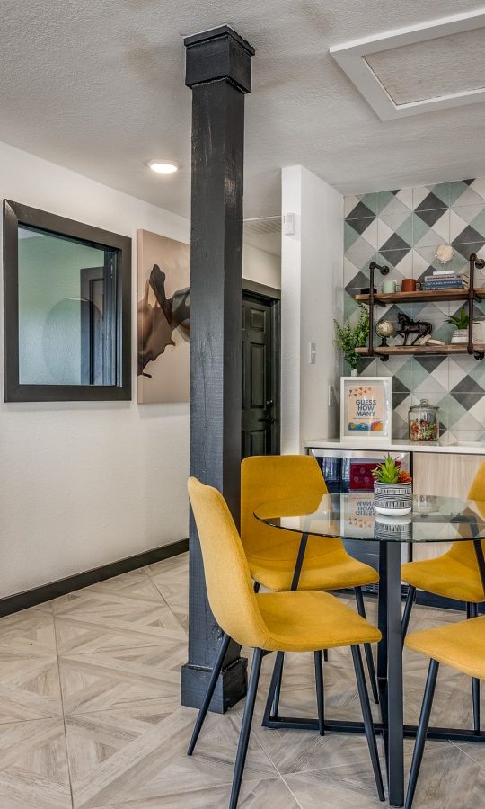 a kitchen with yellow chairs and a table at The Wilder