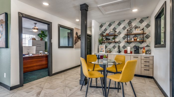 a kitchen with yellow chairs and a table at The Wilder