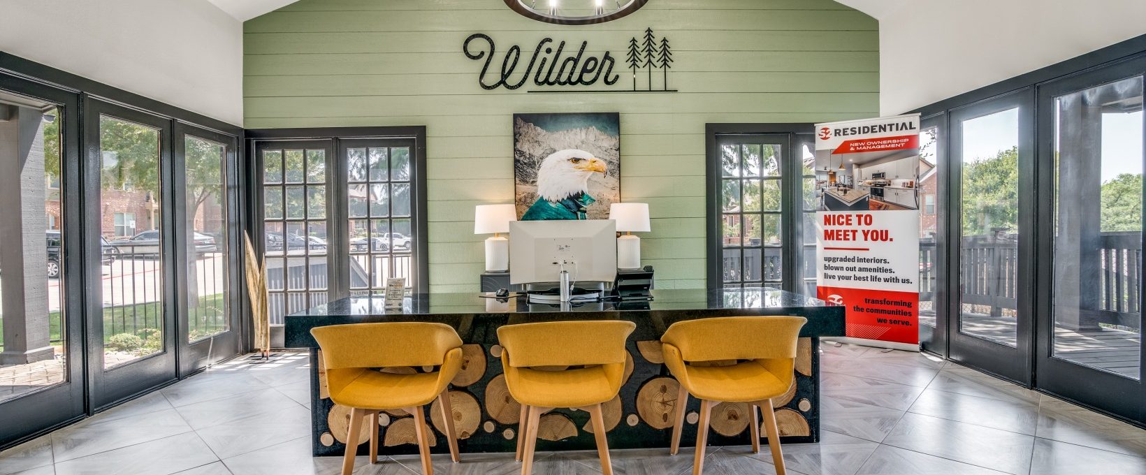 the lobby of a home with a large table and chairs at The Wilder