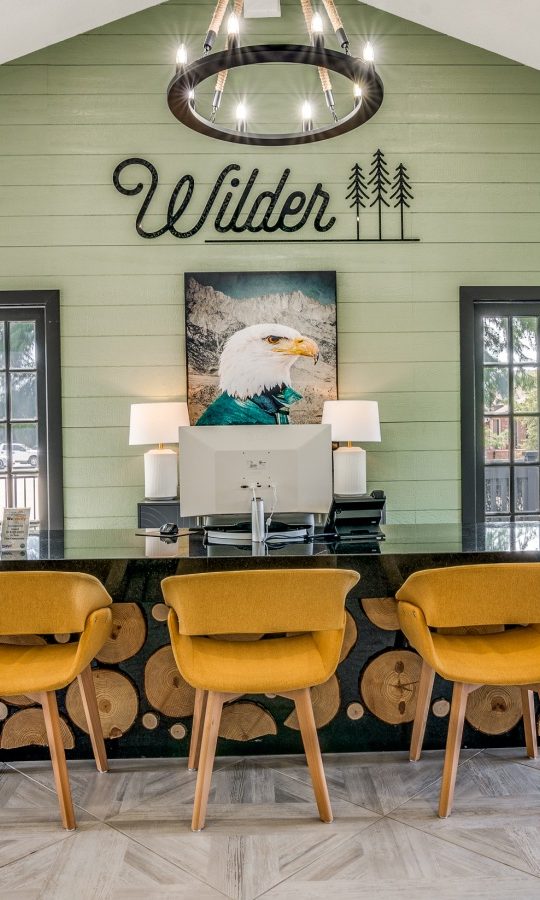 the lobby of a home with a large table and chairs at The Wilder